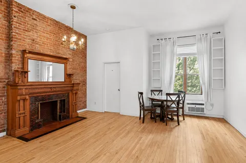 a view of a livingroom with furniture window and wooden floor