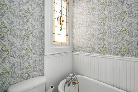 a bathroom with a bathtub and window