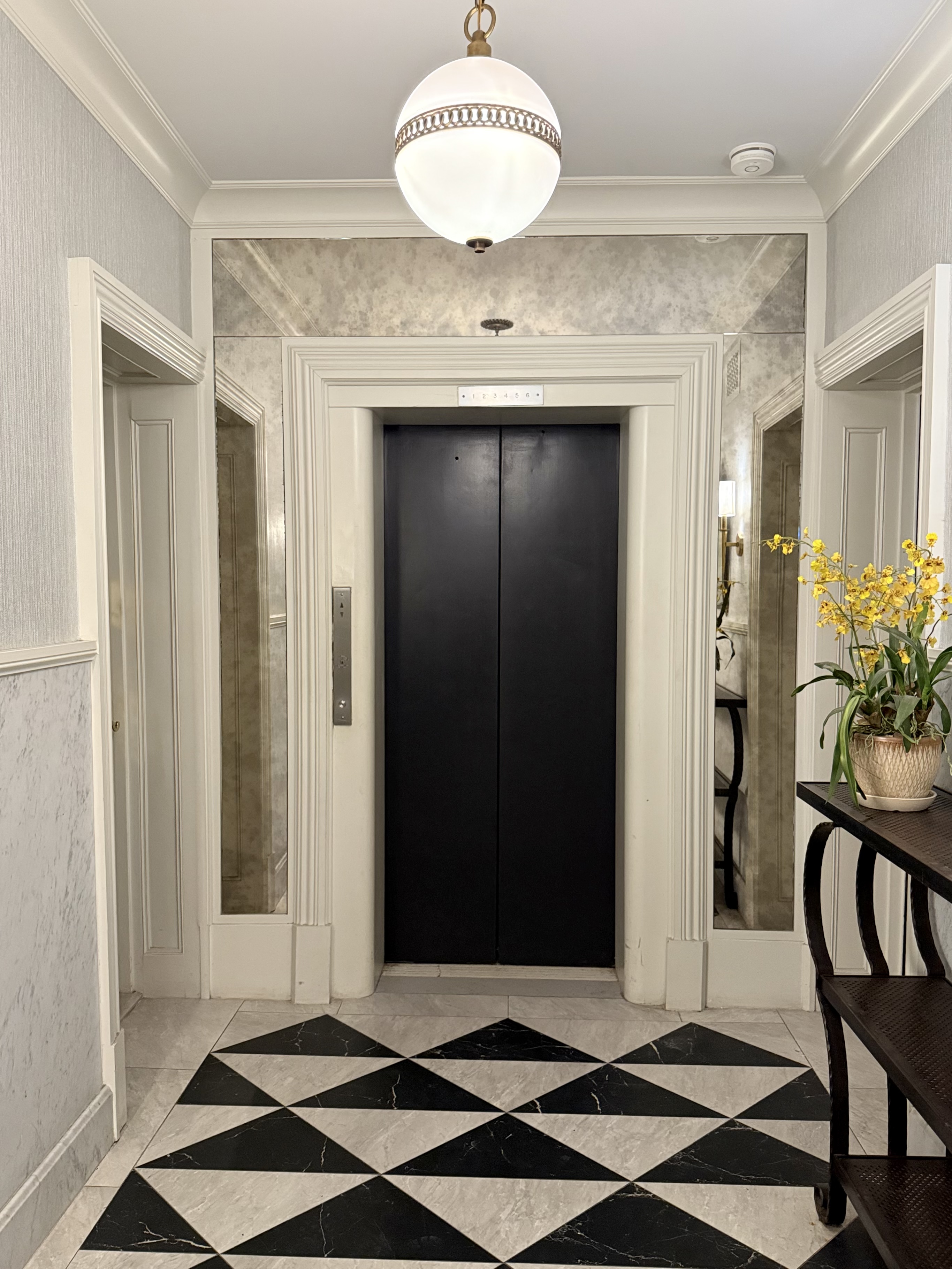 444 East 58th Street, Unit 6C Manhattan, NY 10022 - Photo 8 of 9 a view of a elevator and a mirror in a room