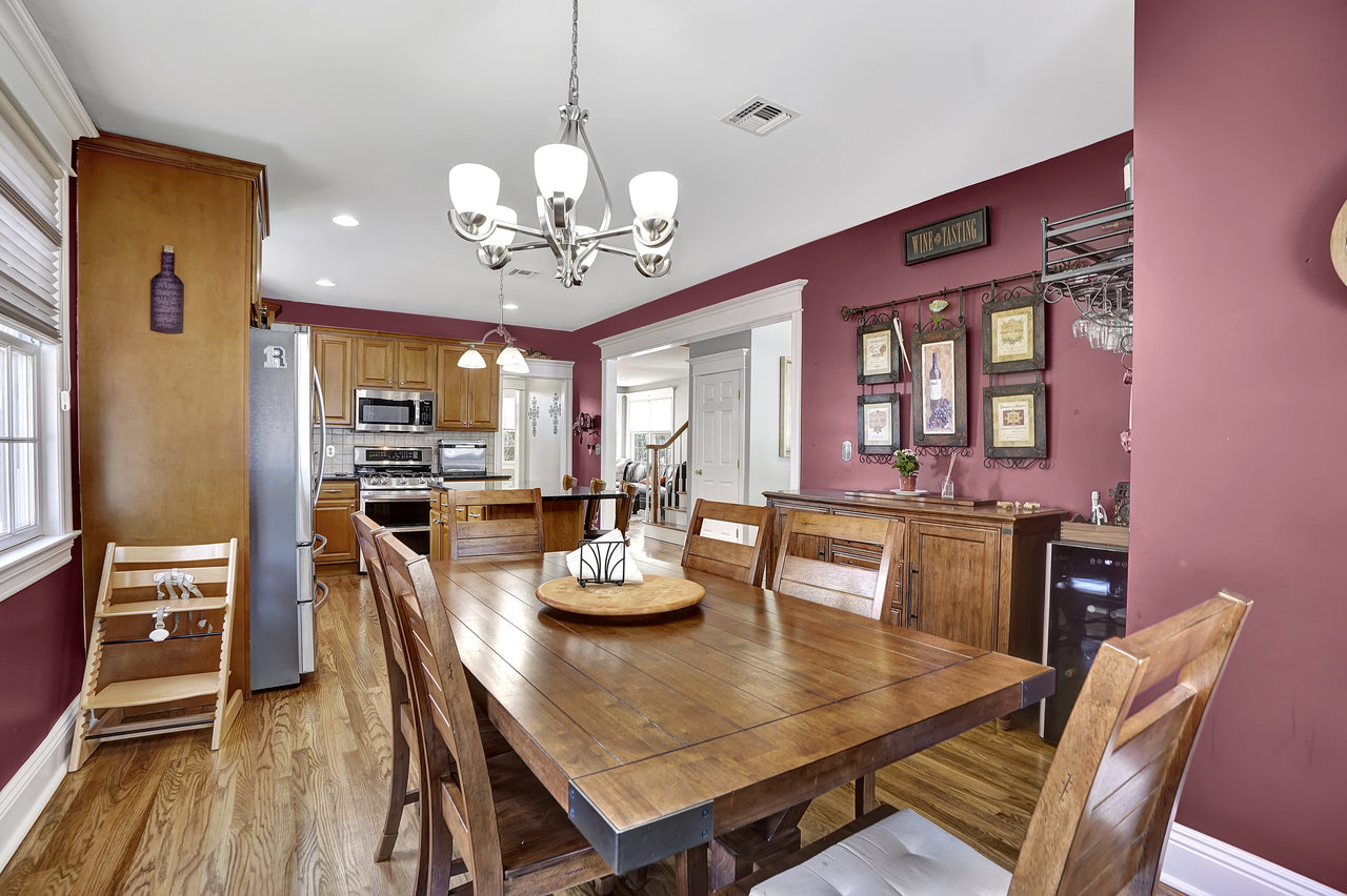 266 Feronia Way Rutherford, NJ 07070 - Photo 14 of 41 a view of a dining room with furniture a chandelier and wooden floor