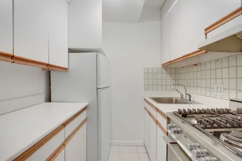 a kitchen that has a sink and a stove