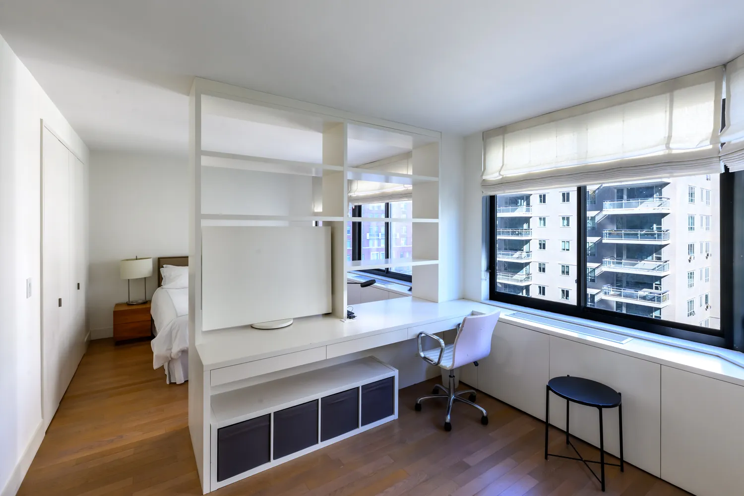 a view of a room with workspace and a window