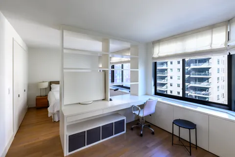 a view of a room with workspace and a window