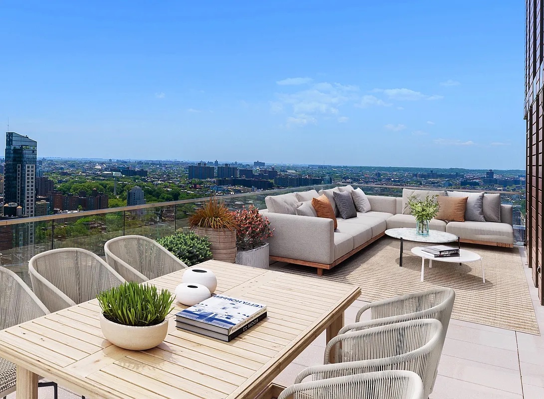 a view of a patio with couches chairs and a potted plant