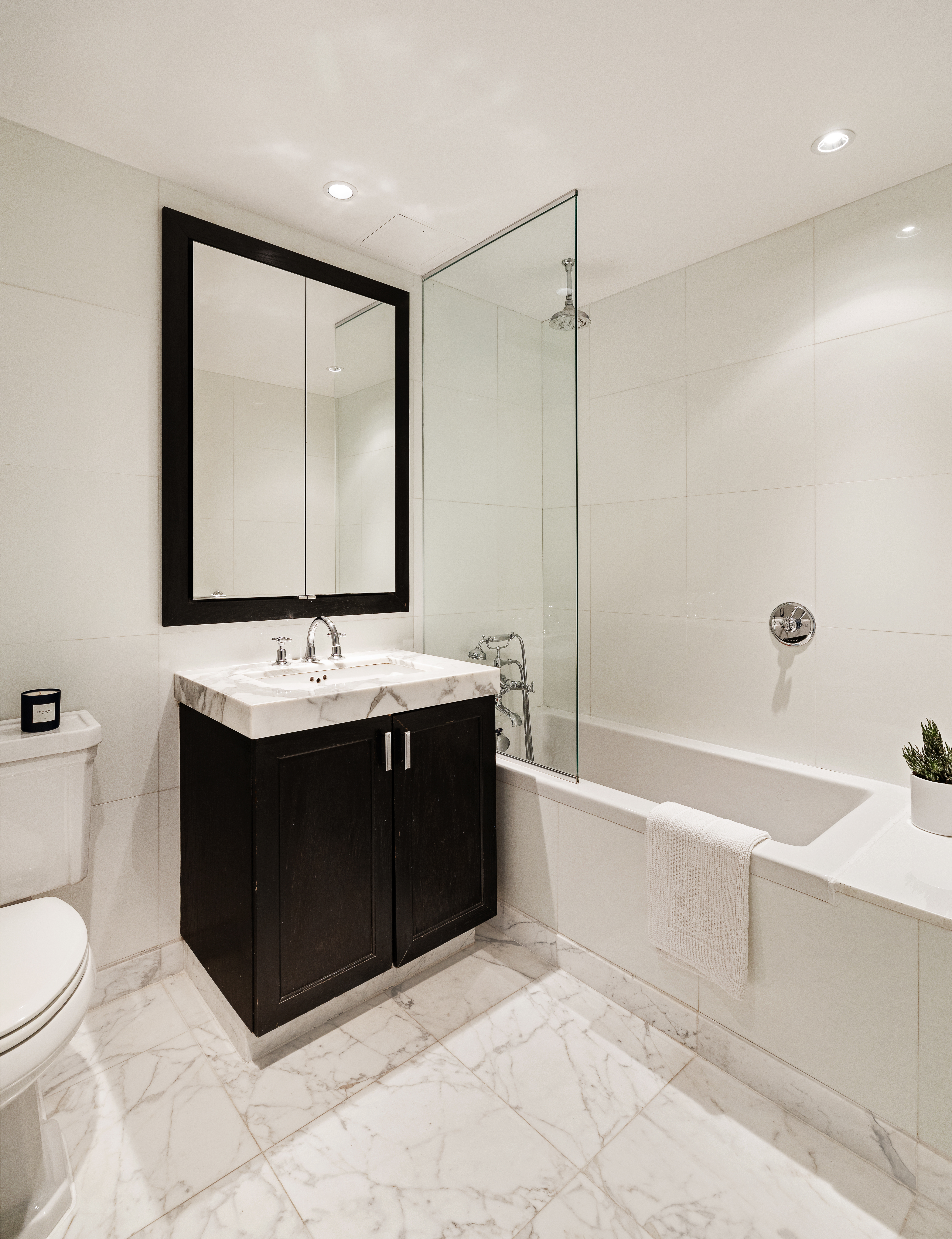 333 Rector Place, Unit 605 Manhattan, NY 10280 - Photo 7 of 13 a bathroom with a bathtub shower sink mirror and toilet