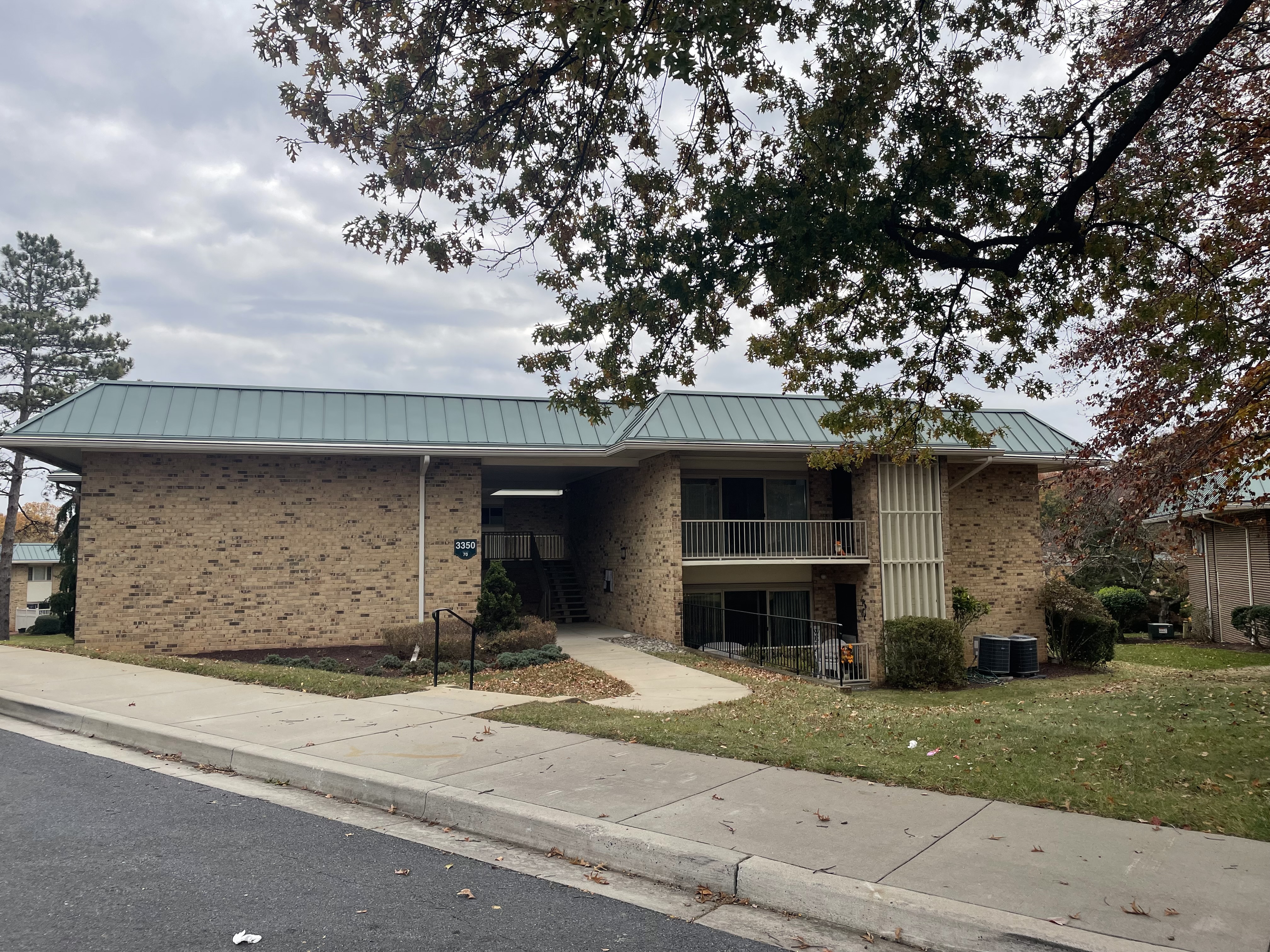 3350 Gleneagles Drive, Unit 1D Silver Spring, MD 20906 - Photo 1 of 2 a front view of a house with a yard garage and outdoor seating