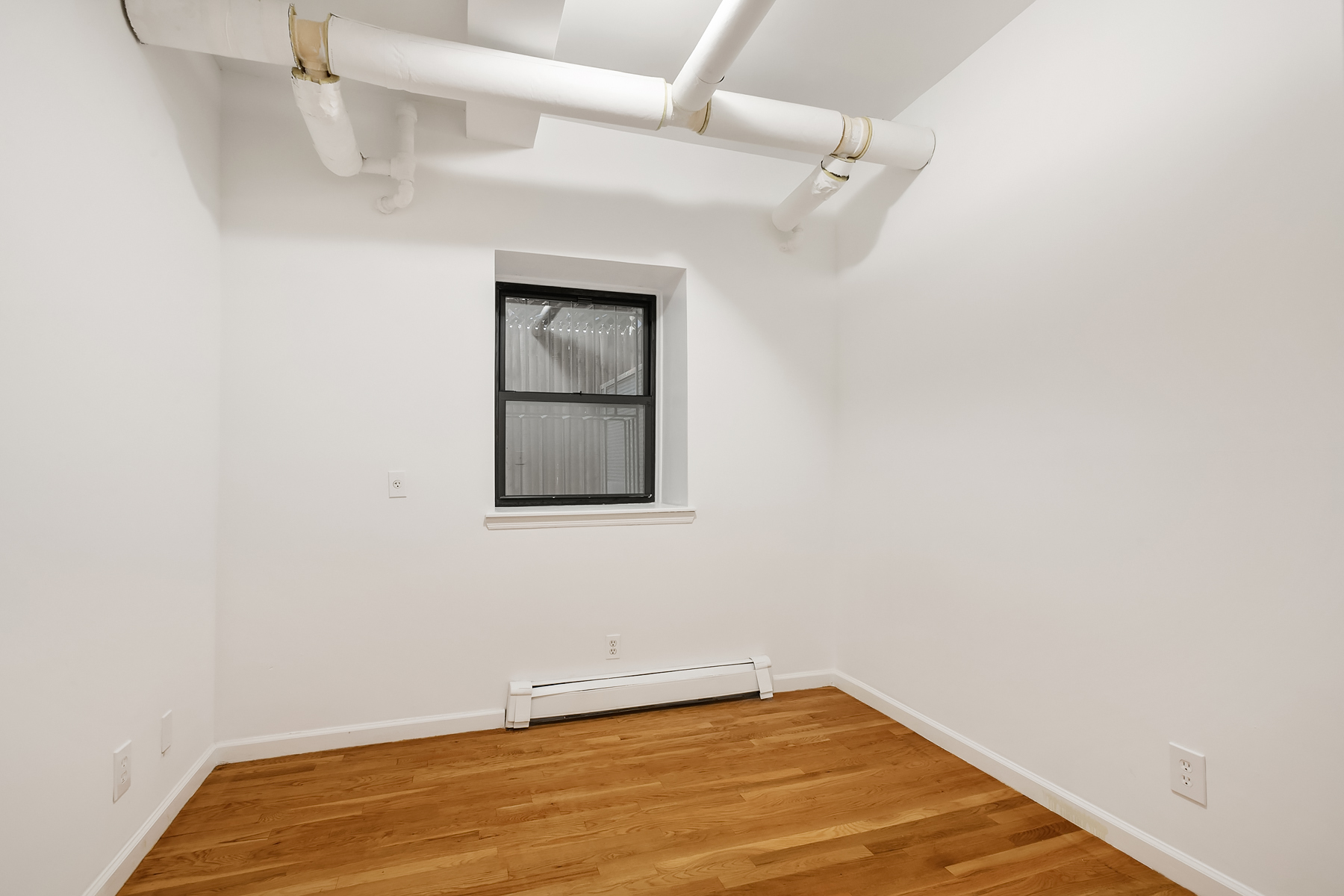 205 West 10th Street, Unit GARDEN Manhattan, NY 10014 - Photo 6 of 8 a view of a room with wooden floor