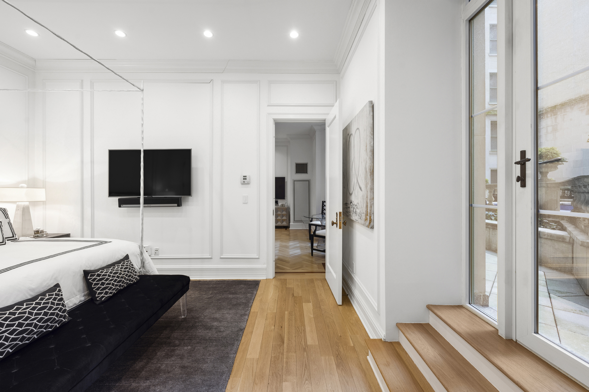 1 Central Park South, Unit 510 Manhattan, NY 10019 - Photo 8 of 23 a living room with a flat screen tv a rug and a chandelier