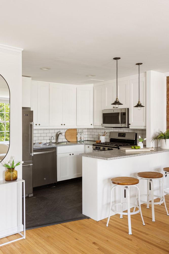 a kitchen with stainless steel appliances a stove top oven a sink a counter space and cabinets