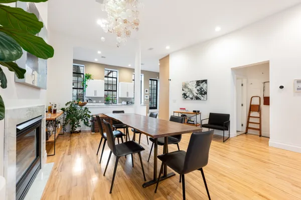 a view of a dining room with furniture and wooden floor