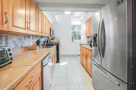 a kitchen with a refrigerator and a sink