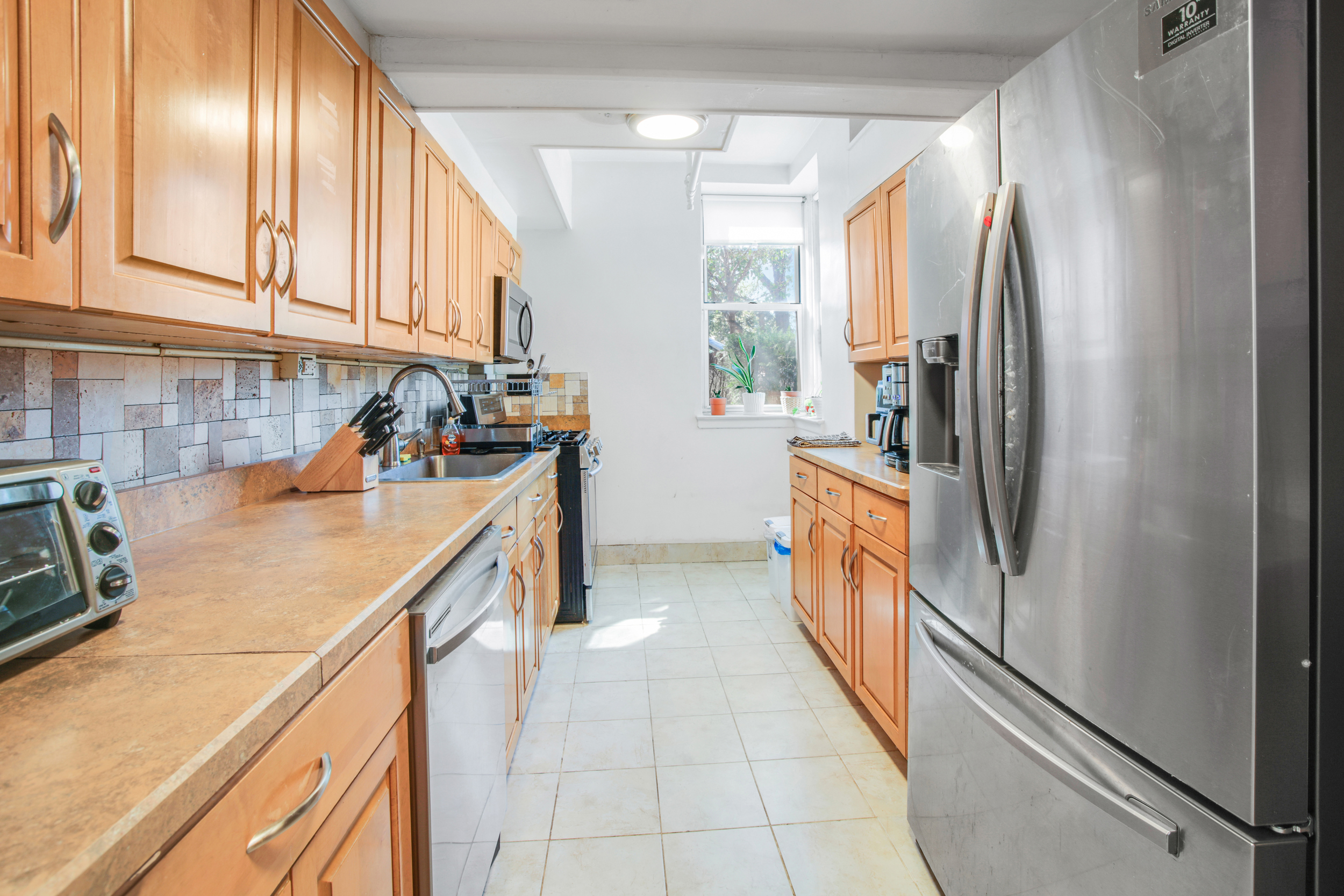 9801 Shore Road, Unit BB Brooklyn, NY 11209 - Photo 6 of 13 a kitchen with a refrigerator and a sink