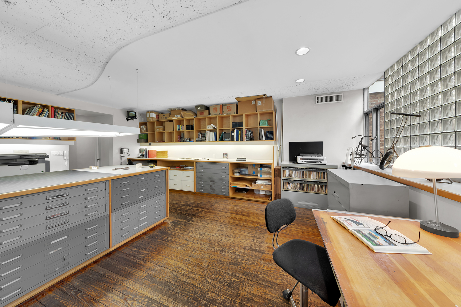 219 East 49th Street Manhattan, NY 10017 - Photo 11 of 19 a kitchen with stainless steel appliances granite countertop a sink dishwasher a stove a dining table and chairs with wooden floor