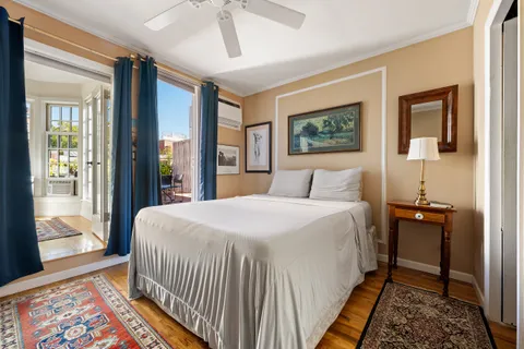 a bedroom with a bed and a painting on the wall