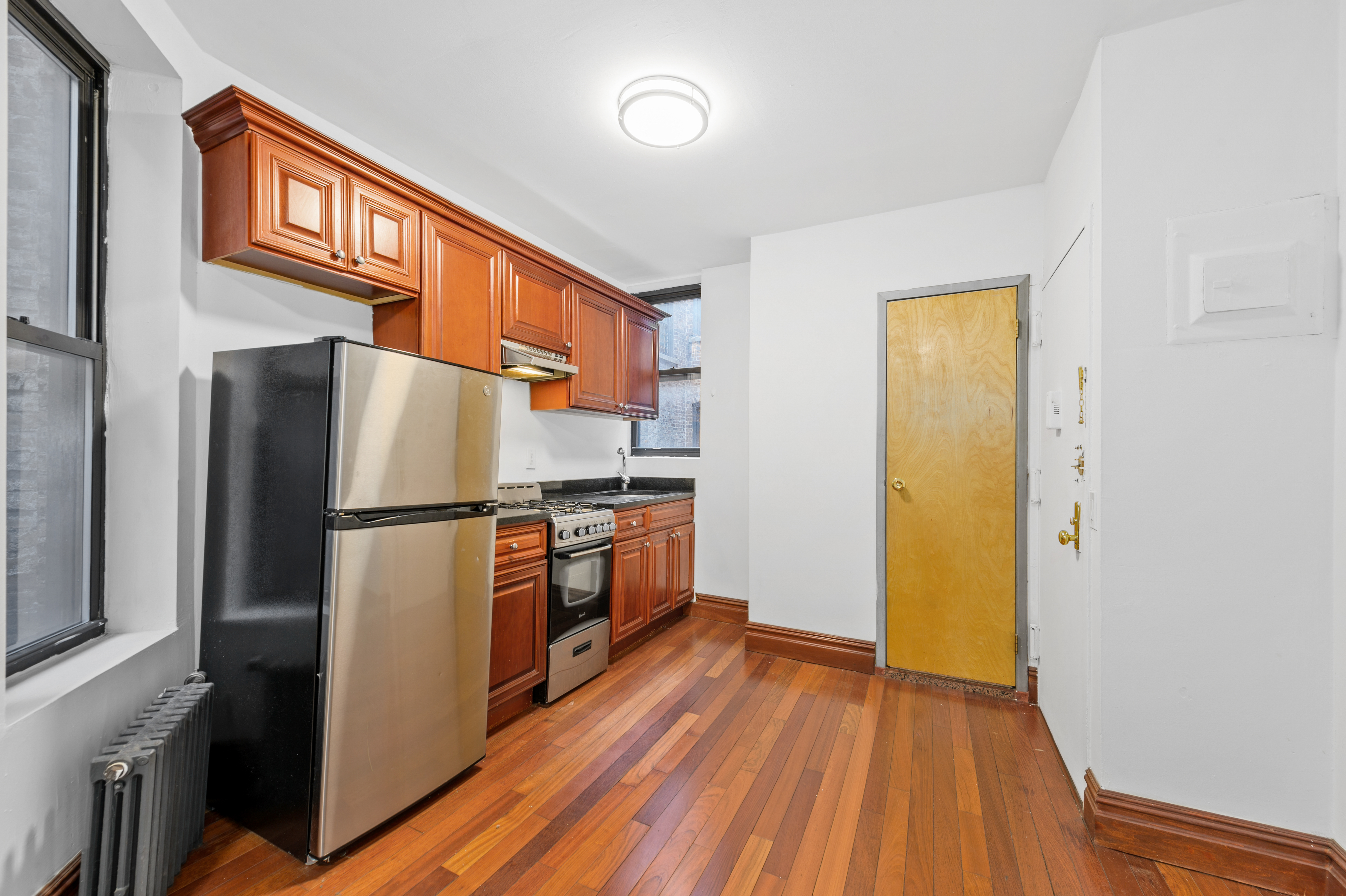 a kitchen with stainless steel appliances a refrigerator and a stove top oven