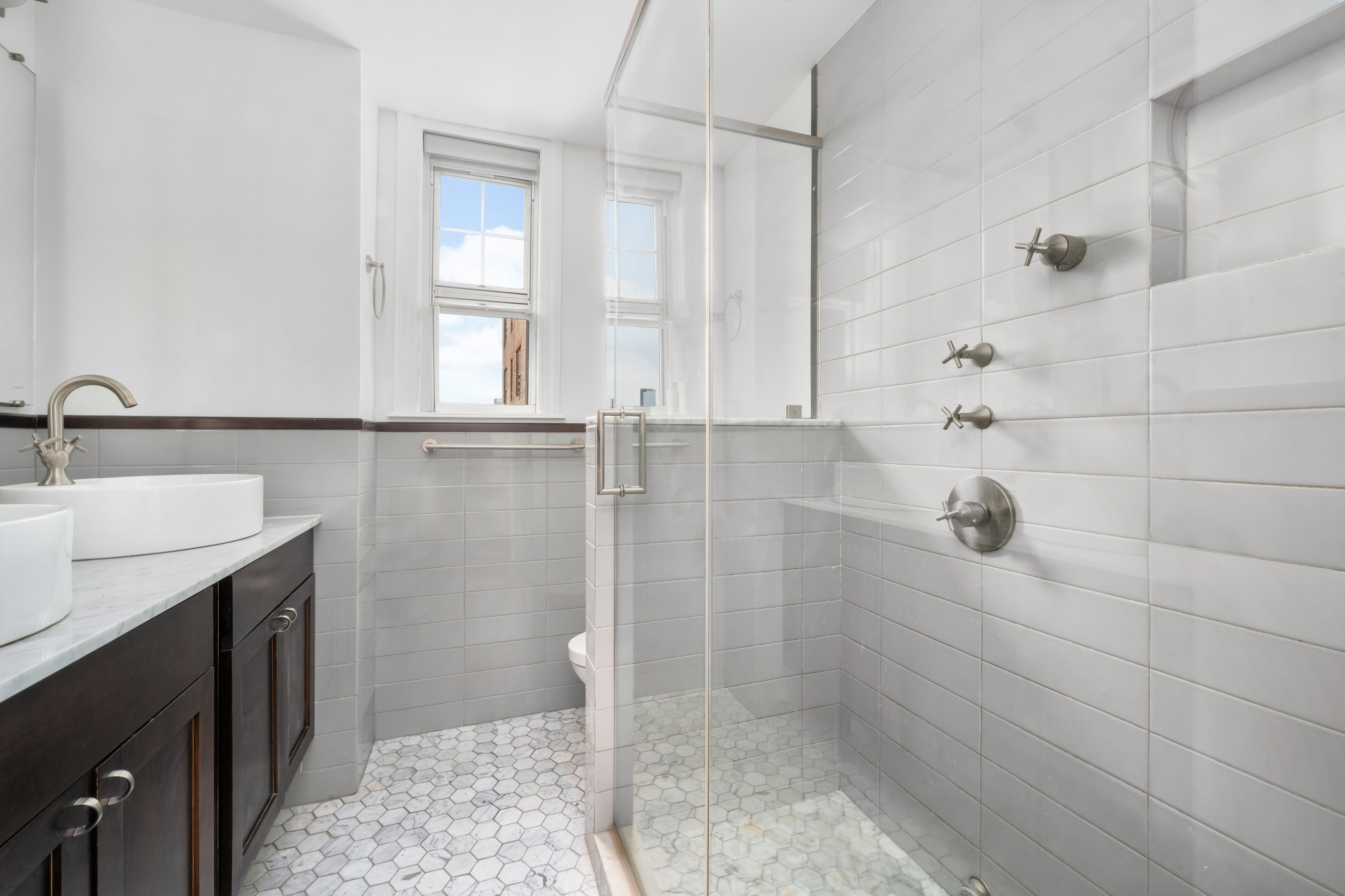 170 2nd Avenue, Unit 10E Manhattan, NY 10003 - Photo 8 of 12 a bathroom with a sink and a shower