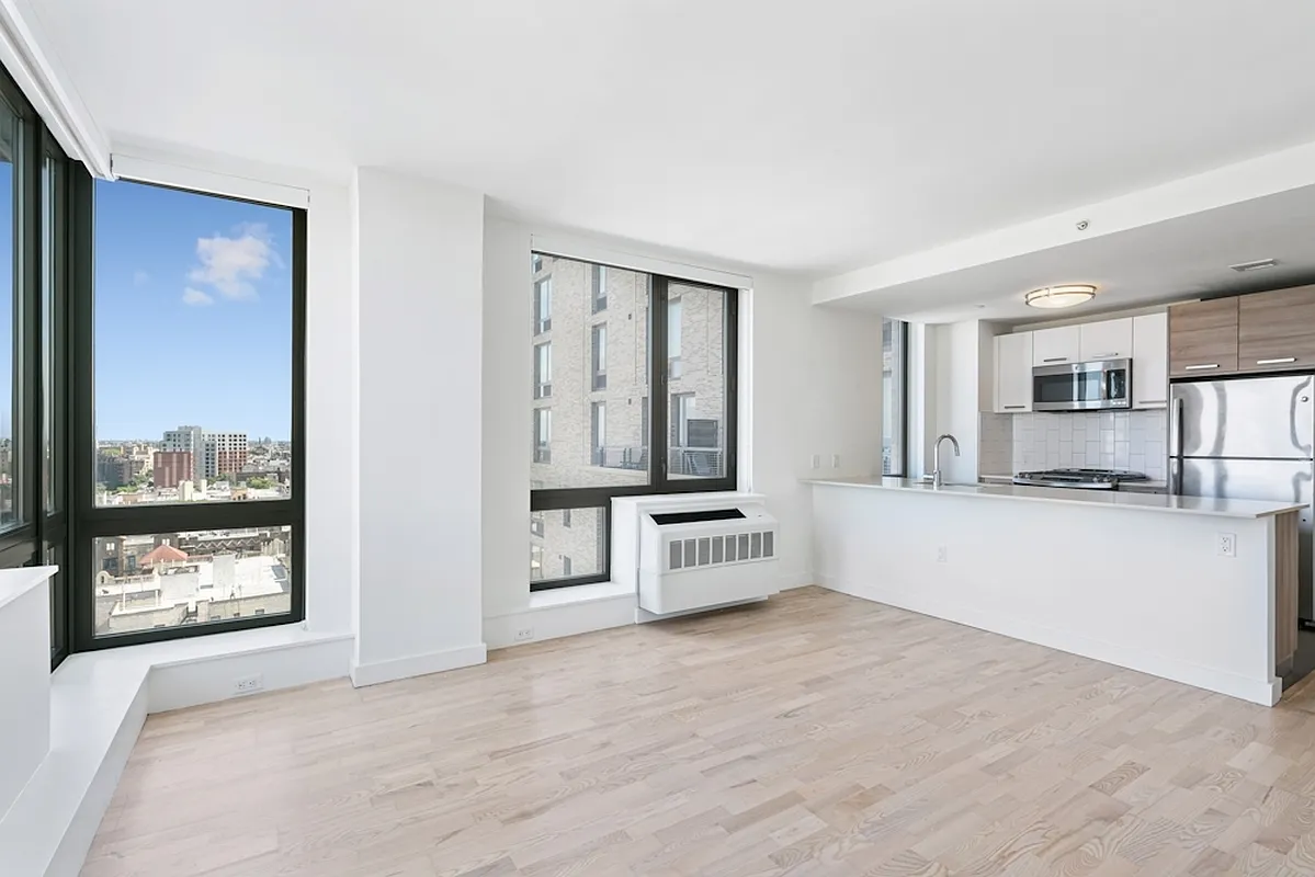 626 Flatbush Avenue, Unit 20J Brooklyn, NY 11225 - Photo 1 of 13 a large white kitchen with stainless steel appliances a large window and a counter top space