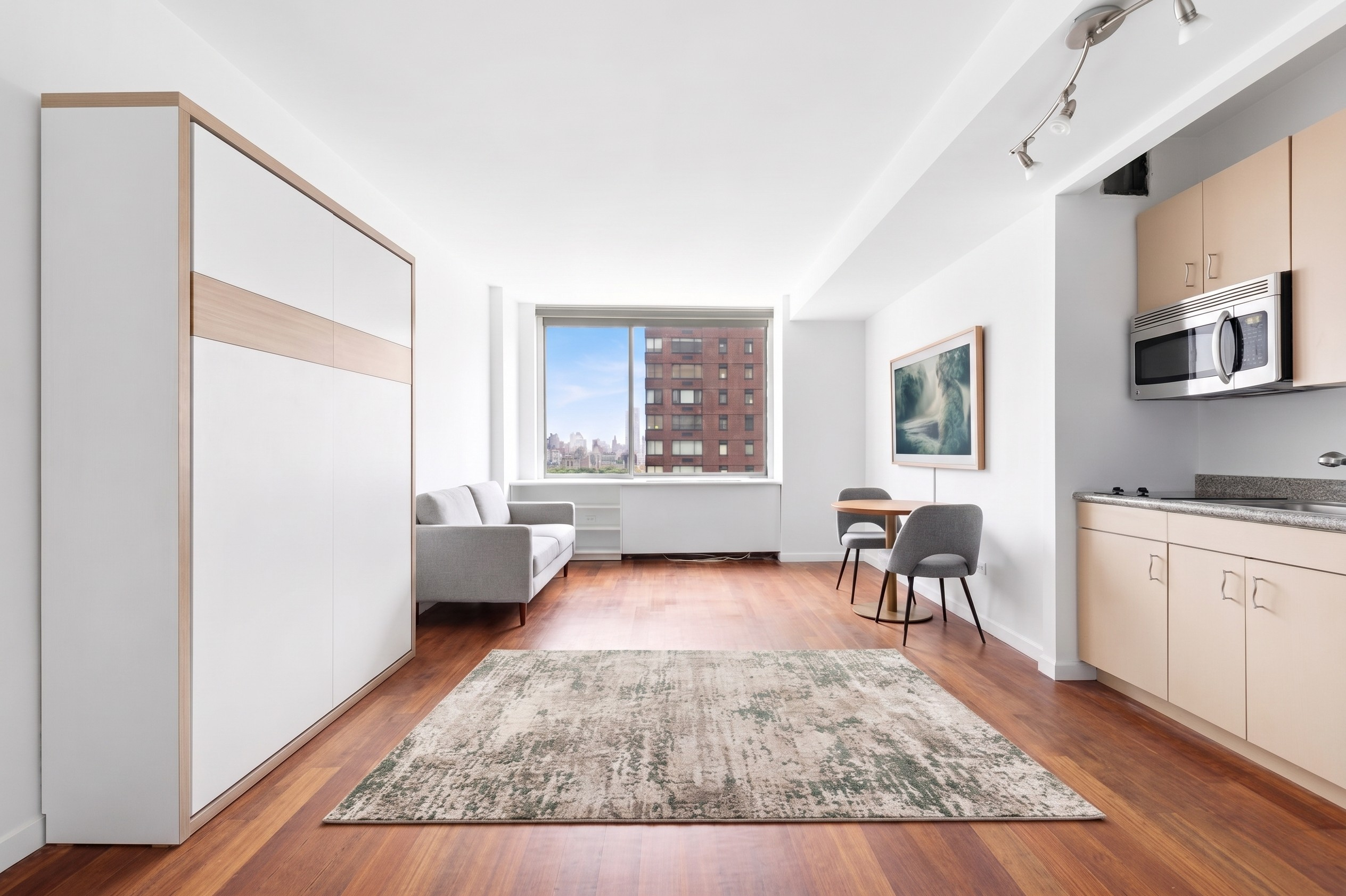 111 West 67th Street, Unit 24L Manhattan, NY 10023 - Photo 2 of 10 a living room with furniture and a window