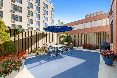 a view of a patio with a table and chairs