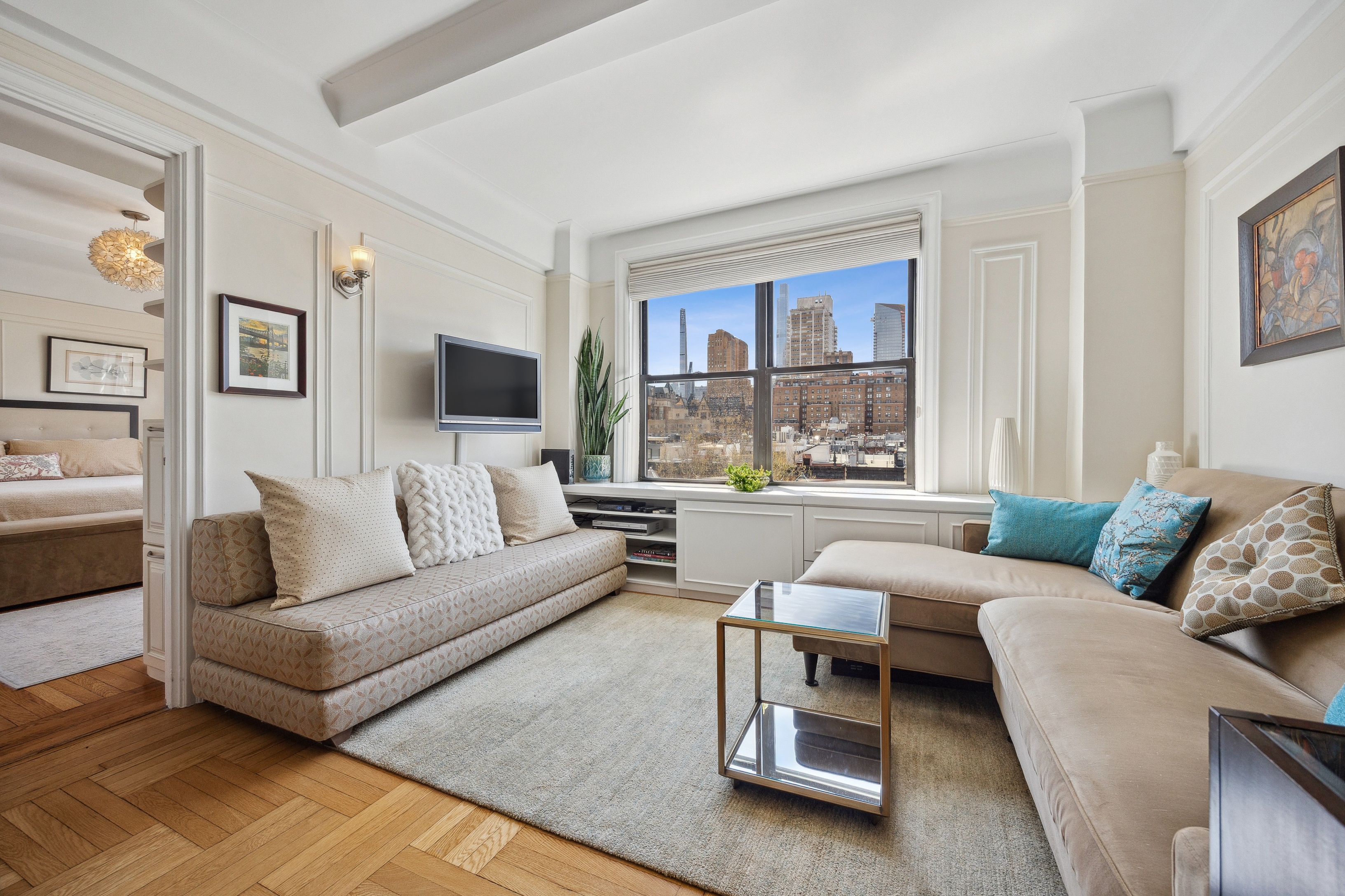 40 West 77th Street, Unit 8C Manhattan, NY 10024 - Photo 2 of 21 a living room with furniture and a large window