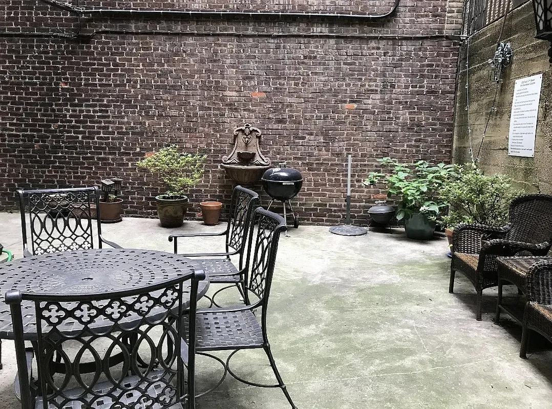 a view of a patio with table and chairs and potted plants