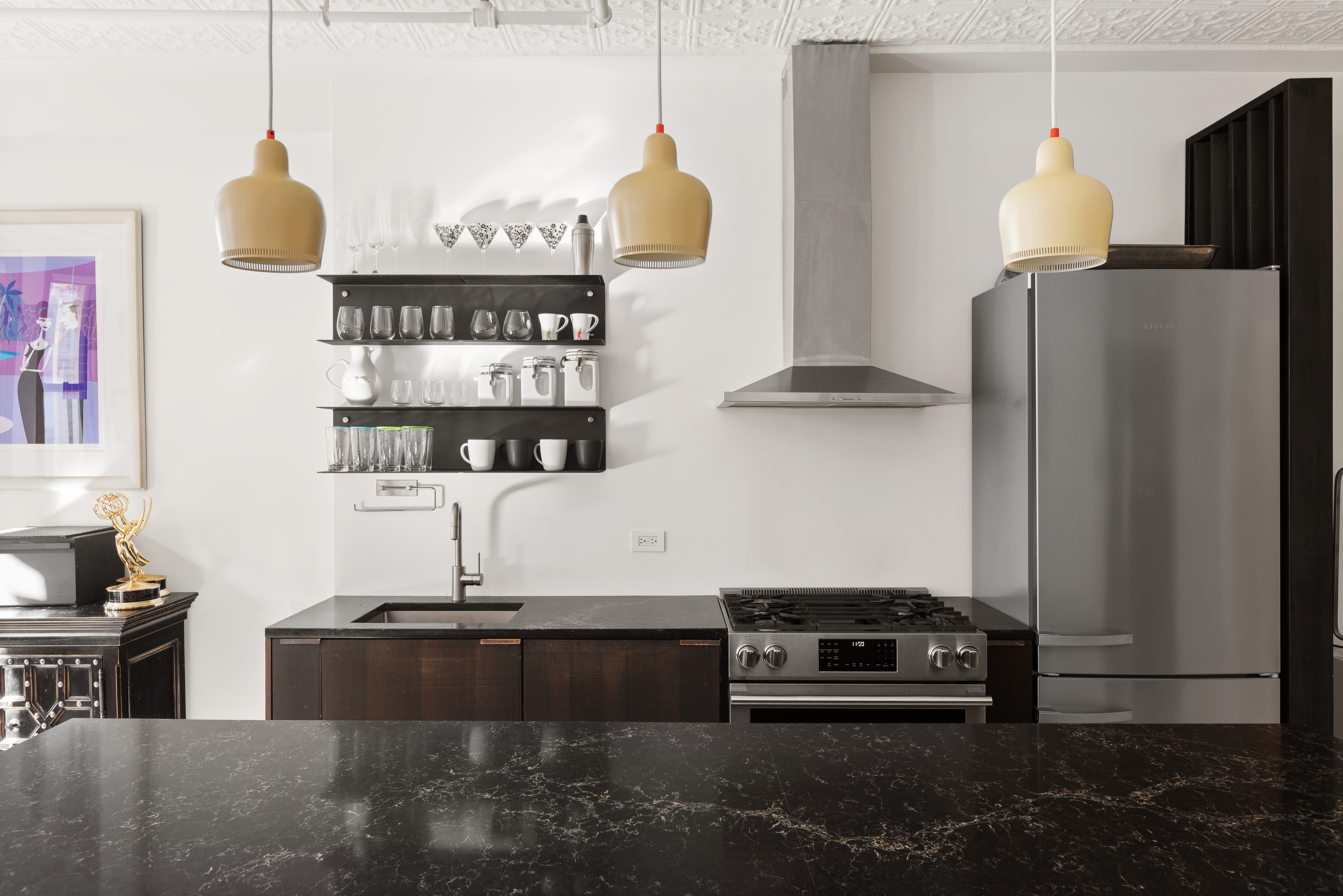 133-131 West 28th Street, Unit 7A Manhattan, NY 10001 - Photo 5 of 11 a kitchen with stainless steel appliances granite countertop a refrigerator and a stove
