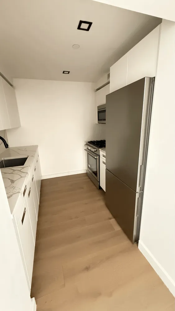 a kitchen with stainless steel appliances a refrigerator and a stove
