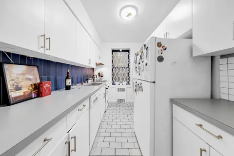 a kitchen with stainless steel appliances a refrigerator a sink and cabinets