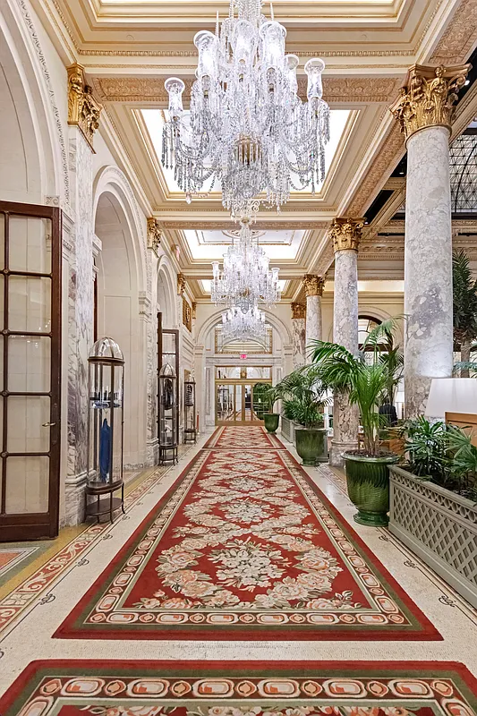 1 Central Park South, Unit 1010 Manhattan, NY 10019 - Photo 10 of 11 a view of a hallway with a chandelier and dining table