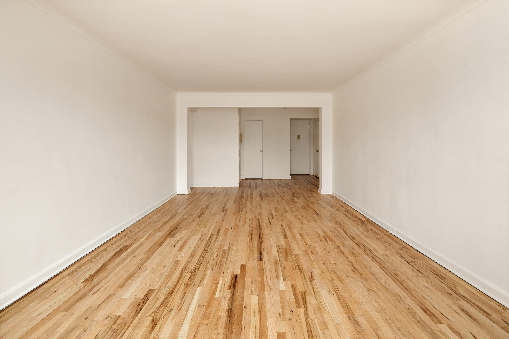 1717 East 18th Street, Unit 4P Brooklyn, NY 11229 - Photo 5 of 8 a view of a room with wooden floor and white walls