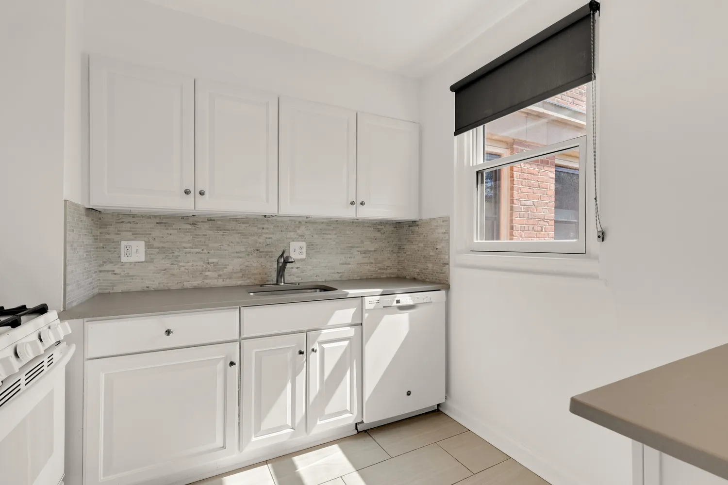 a kitchen with white cabinets