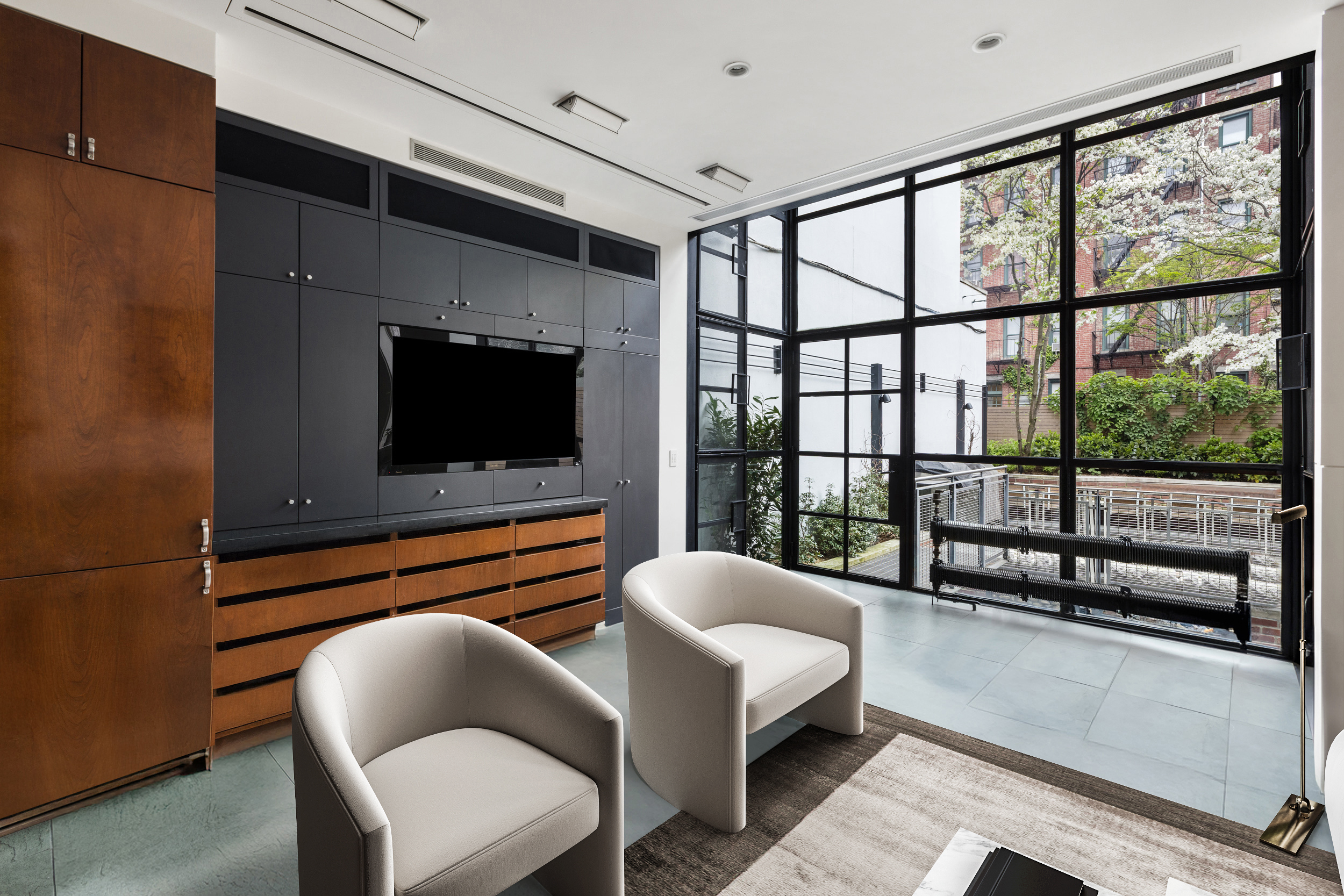 83 Jane Street, Unit TH1 Manhattan, NY 10014 - Photo 5 of 29 a living room with furniture tv and a floor to ceiling window