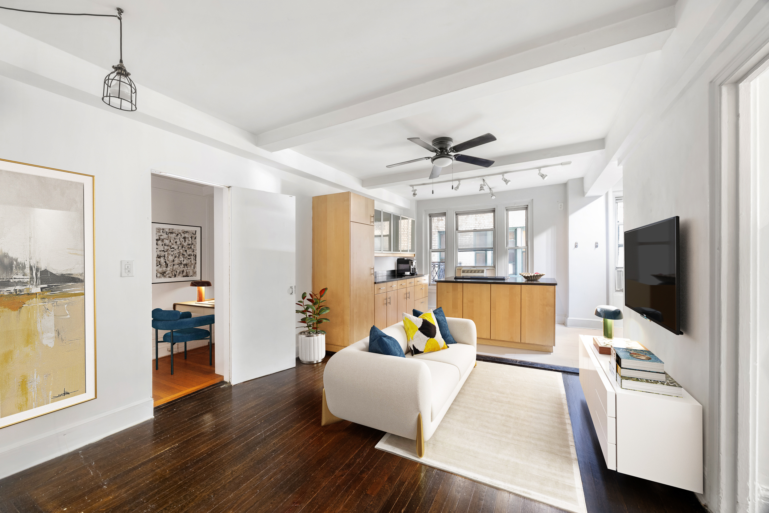 325 West 45th Street, Unit 205 Manhattan, NY 10036 - Photo 1 of 14 a living room with furniture and a flat screen tv