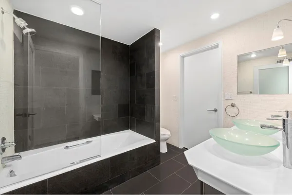 a bedroom with a bed and a potted plant