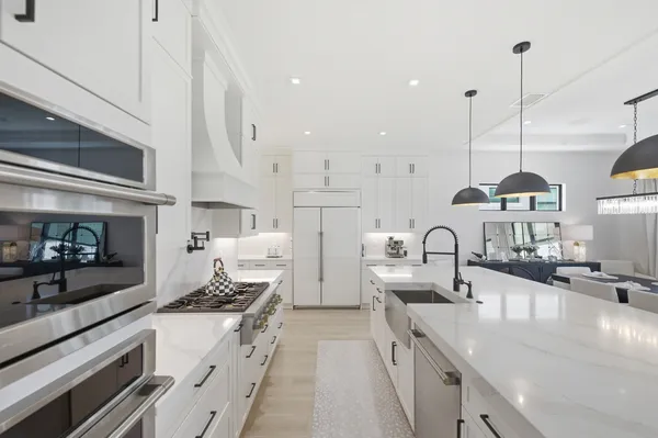 a kitchen with lots of counter space and stainless steel appliances