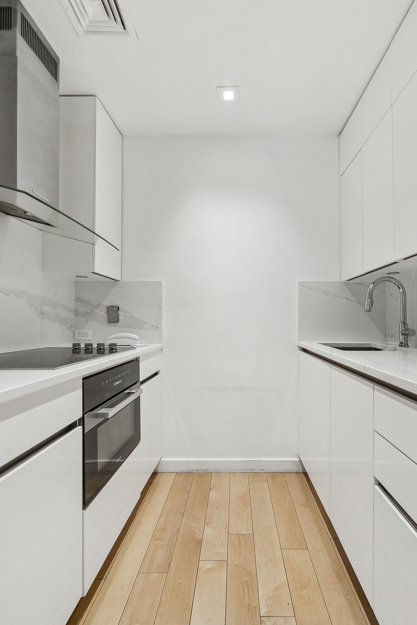 641 5th Avenue, Unit 28B Manhattan, NY 10022 - Photo 8 of 12 a kitchen with a sink cabinets and stainless steel appliances