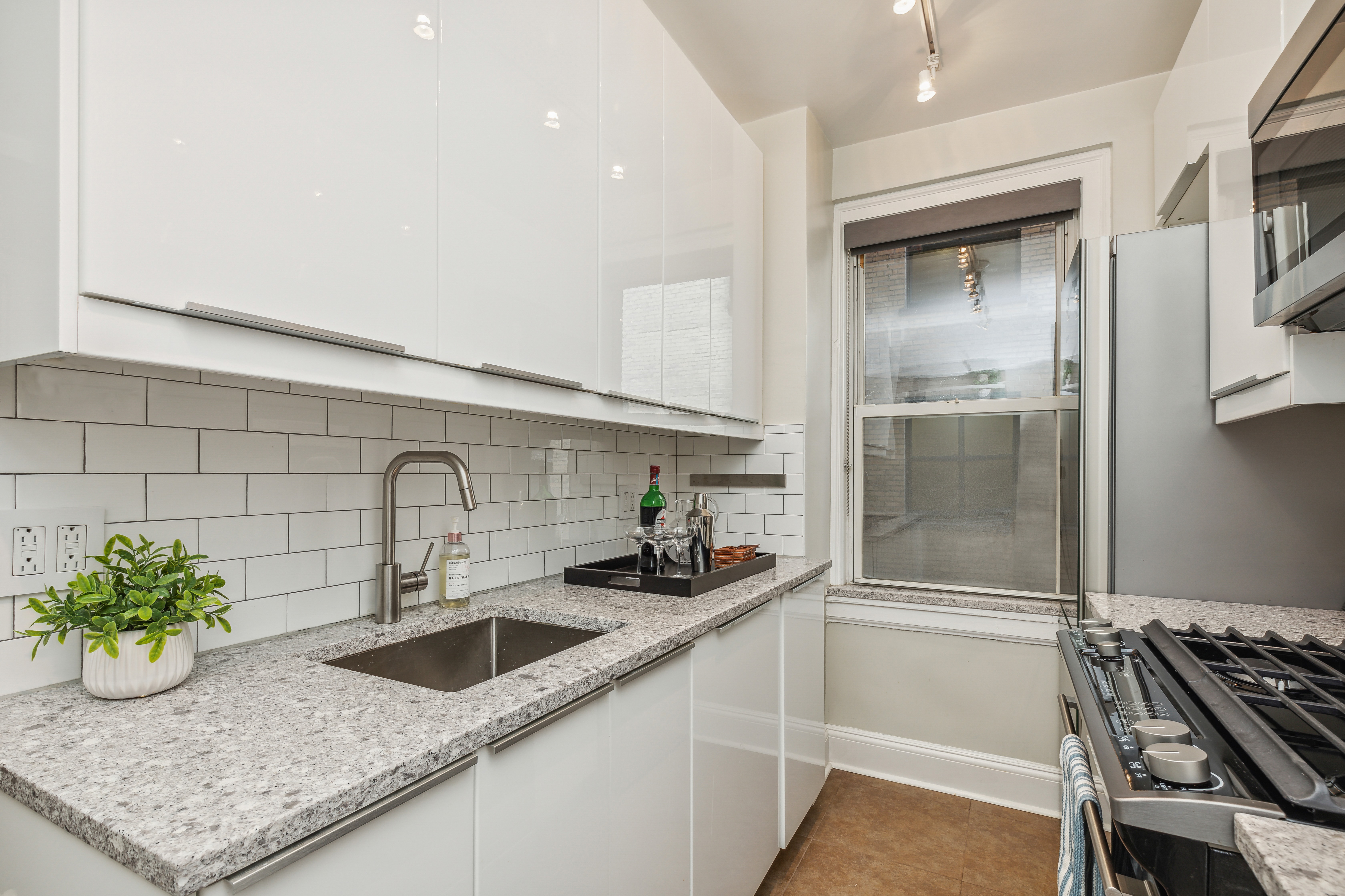 400 East 59th Street, Unit 2D Manhattan, NY 10022 - Photo 3 of 8 a kitchen with counter top space and cabinets