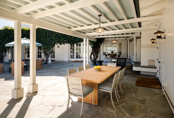 a front view of a house with a yard table and chairs