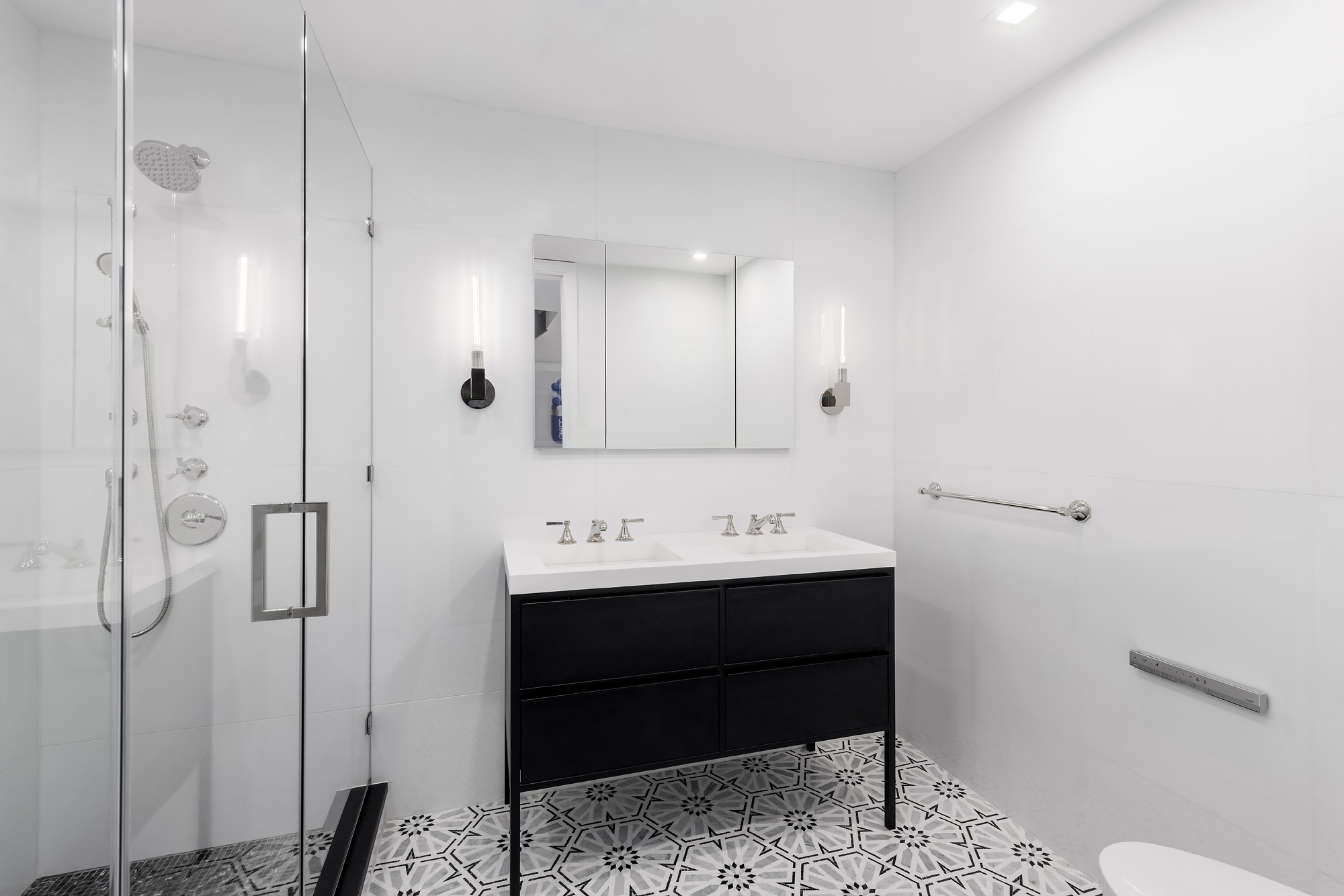 130 East 38th Street Manhattan, NY 10016 - Photo 11 of 16 a bathroom with a sink a toilet and shower