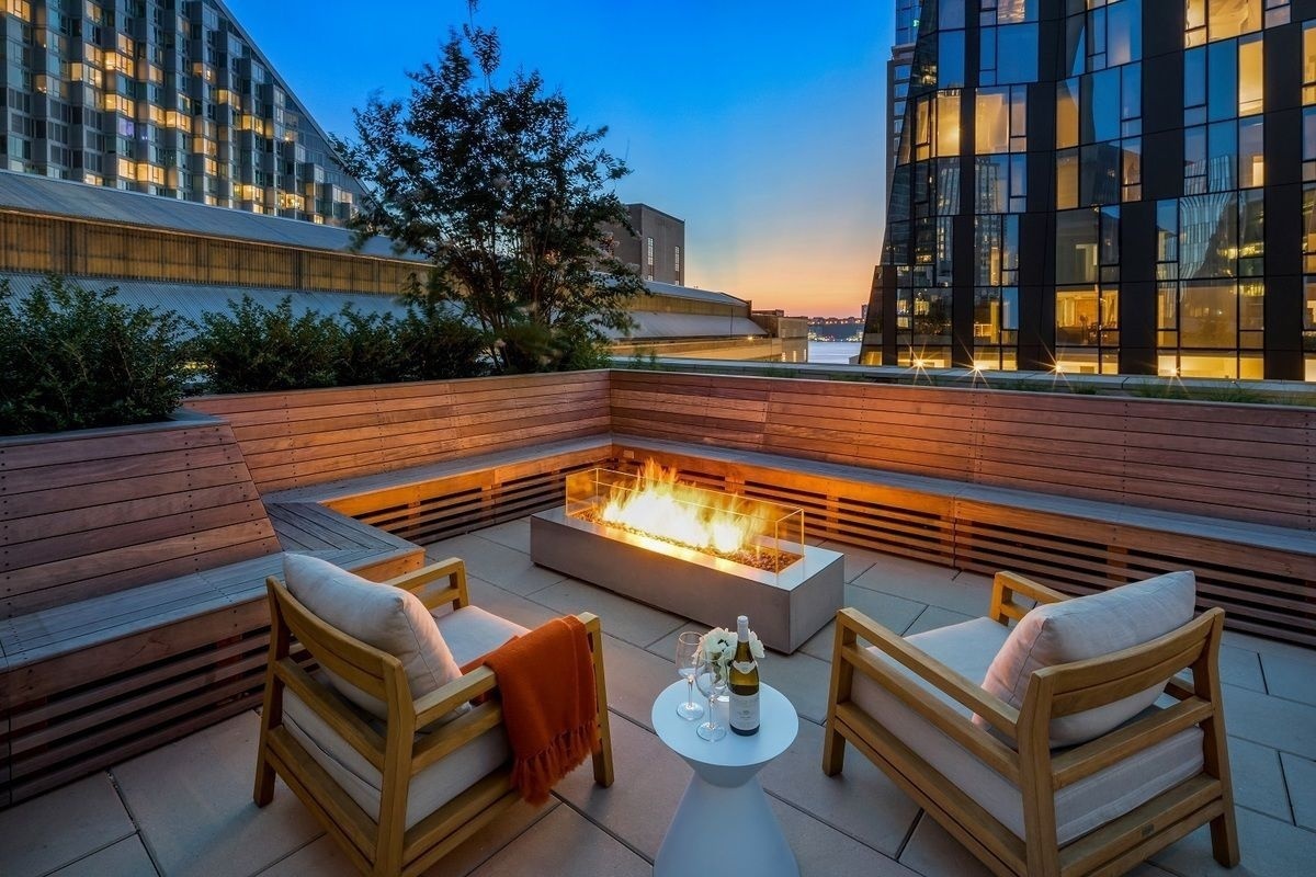 1 West End Avenue, Unit 19J Manhattan, NY 10023 - Photo 21 of 32 a view of a roof deck with couches and wooden floor