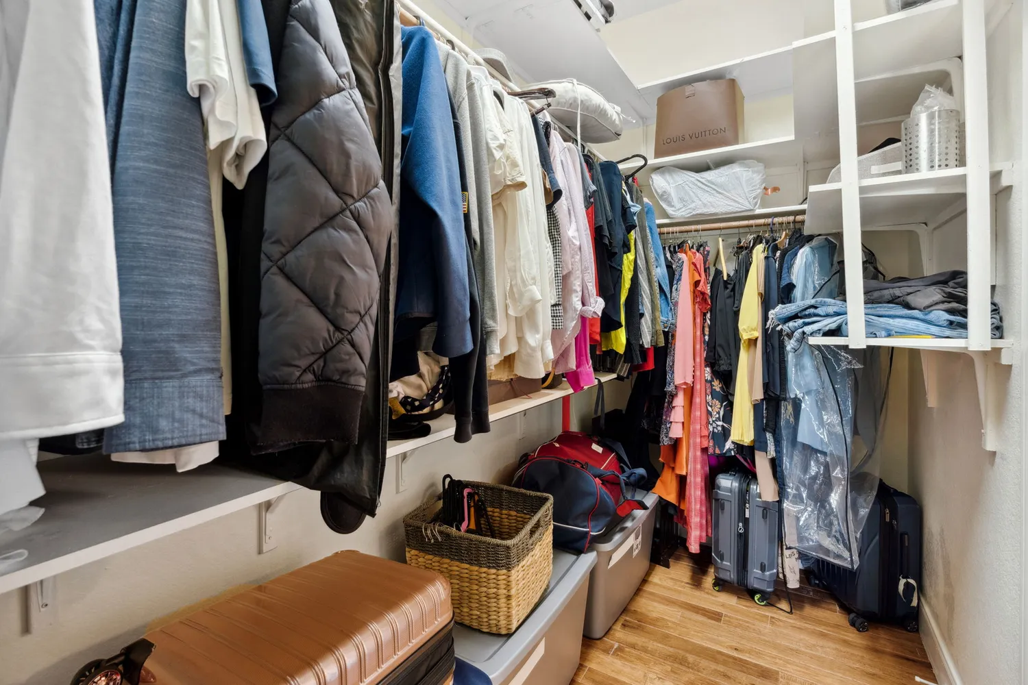 a view of walk in closet with clothes and shoes