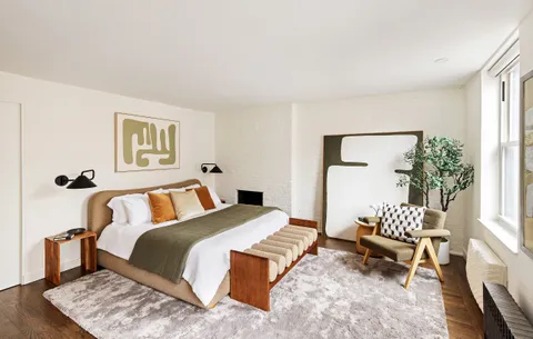 a bedroom with a bed and a couch