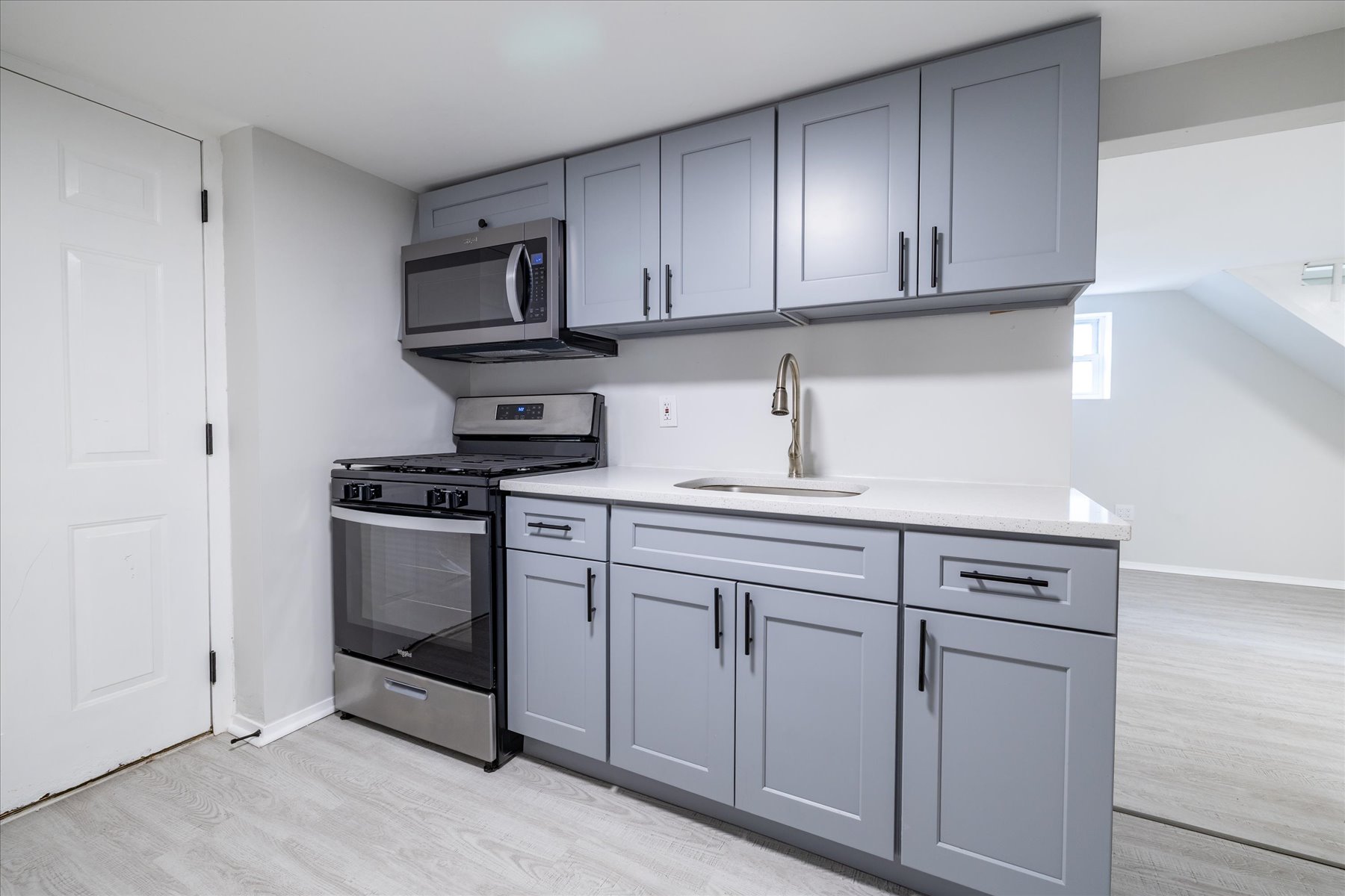 13-03 Brunswick Avenue Queens, NY 11691 - Photo 20 of 27 a kitchen with white cabinets and appliances