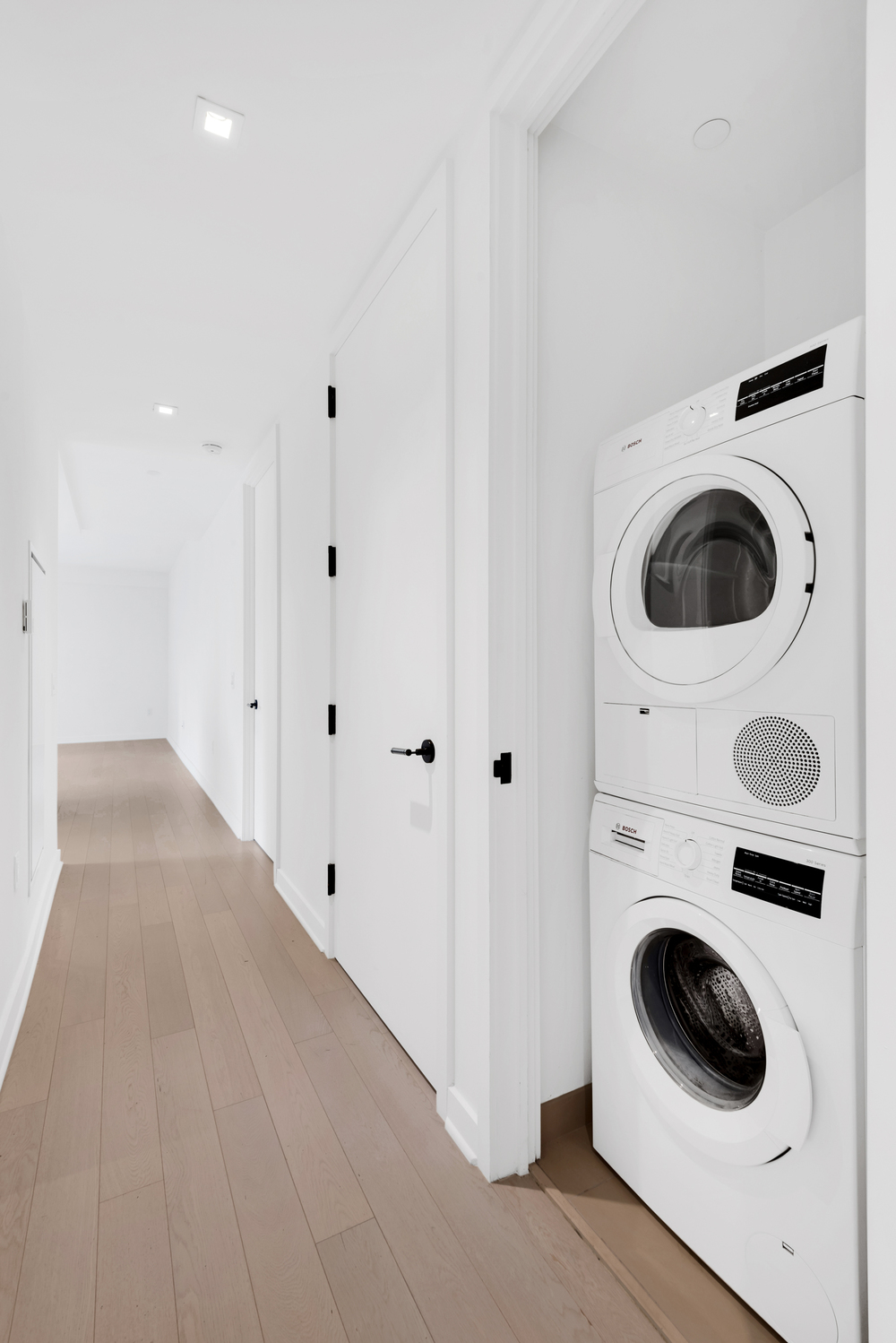 959 1st Avenue, Unit 6P Manhattan, NY 10022 - Photo 10 of 12 a view of a hallway with washer and dryer