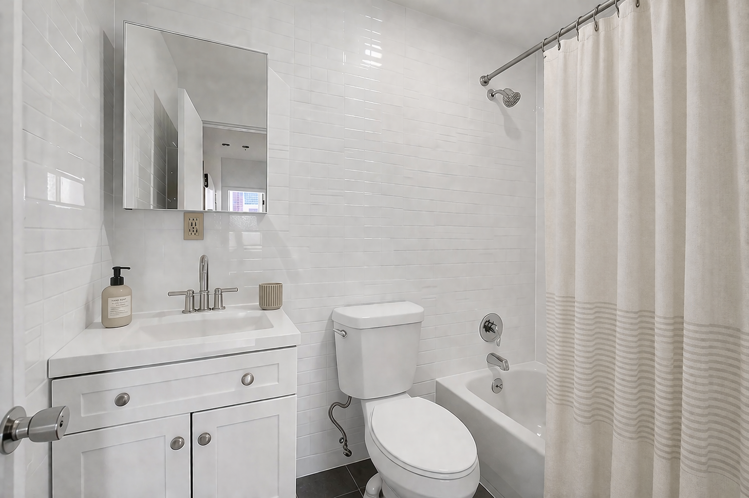 1260 Broadway, Unit 4F Brooklyn, NY 11221 - Photo 4 of 4 a bathroom with a toilet a sink a bath tub and shower curtain