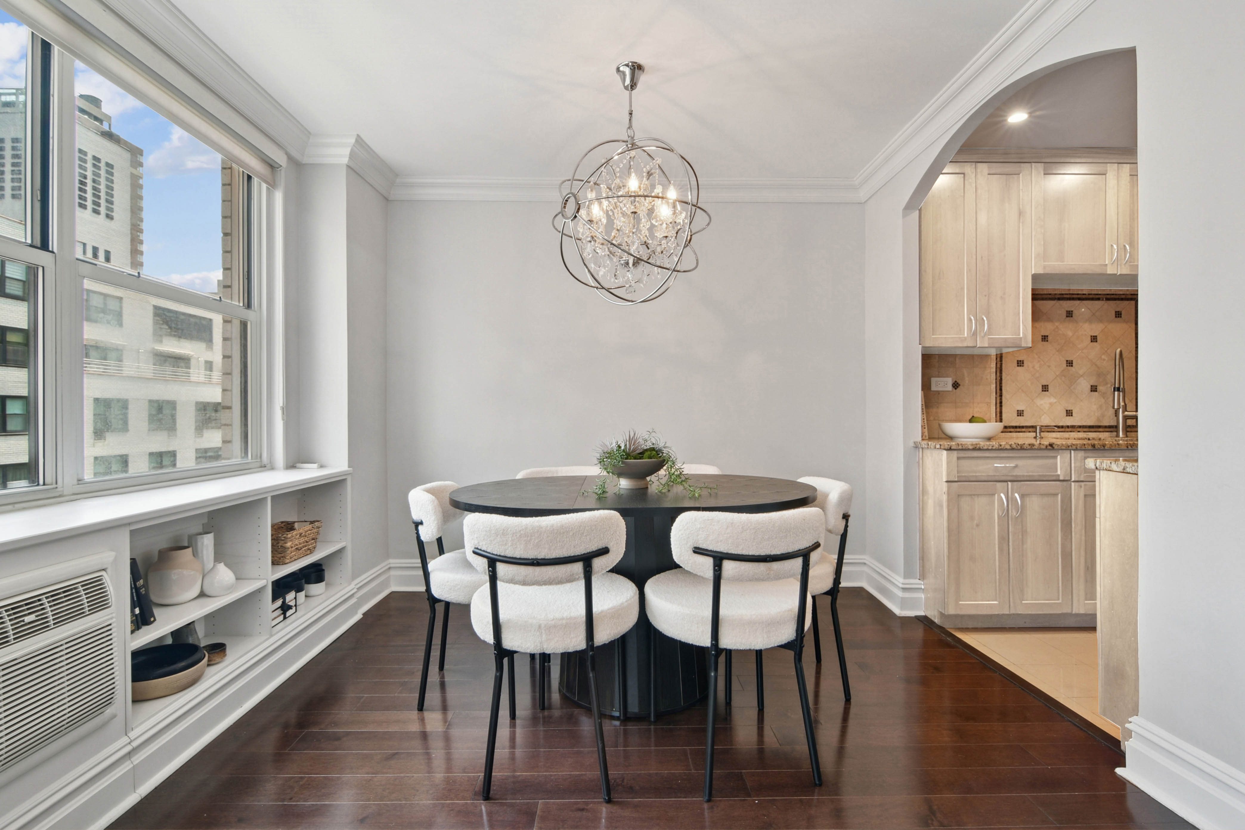 310 East 70th Street, Unit 10E Manhattan, NY 10021 - Photo 2 of 14 a view of a dining room with furniture a chandelier and wooden floor