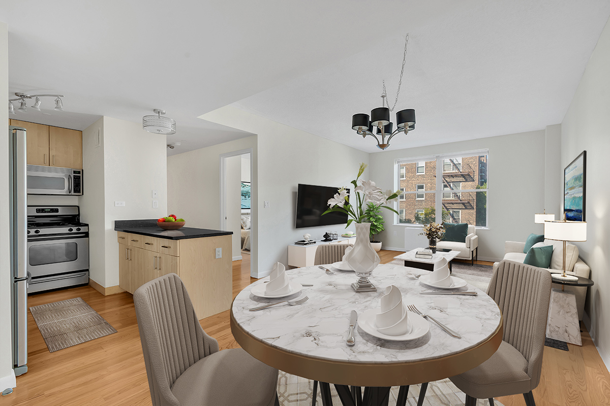 736 West 187th Street, Unit 502 Manhattan, NY 10033 - Photo 5 of 11 a living room with furniture a flat screen tv and kitchen view