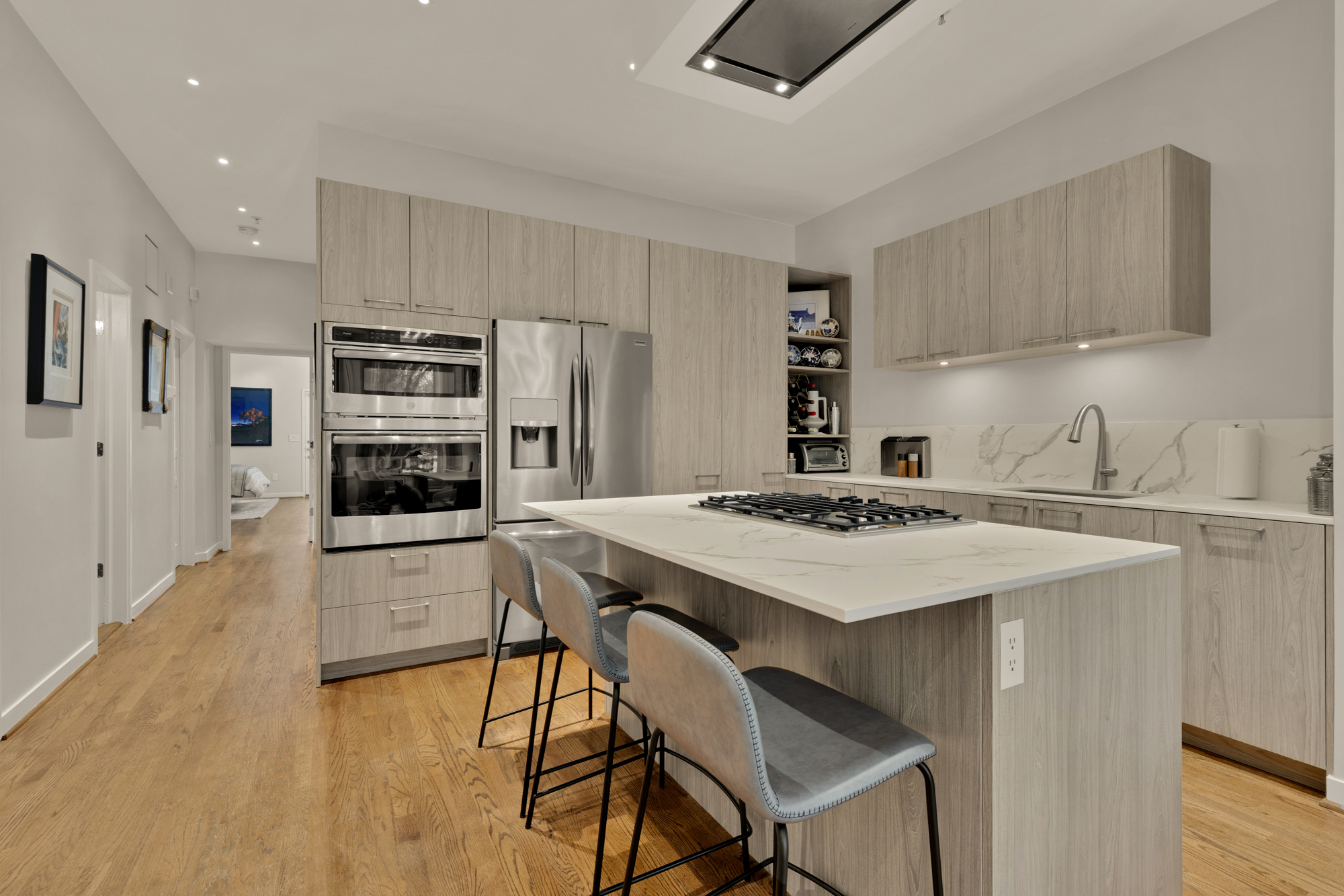 1407 15th Street Northwest, Unit 2 Washington, DC 20005 - Photo 5 of 24 a kitchen with stainless steel appliances a stove a sink a refrigerator and white cabinets with wooden floor