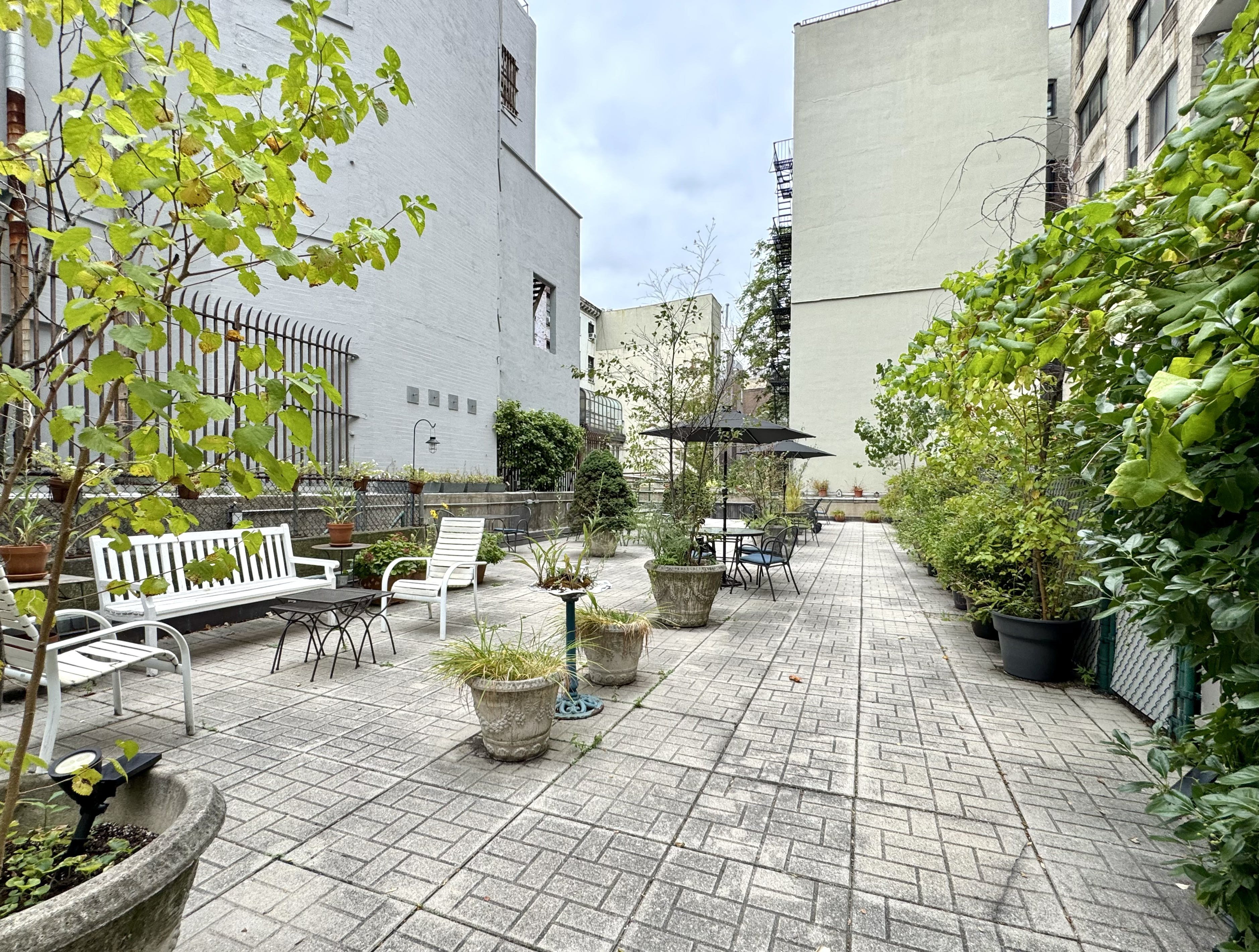85 8th Avenue, Unit 5-H Manhattan, NY 10011 - Photo 8 of 11 a view of a patio with table and chairs and potted plants