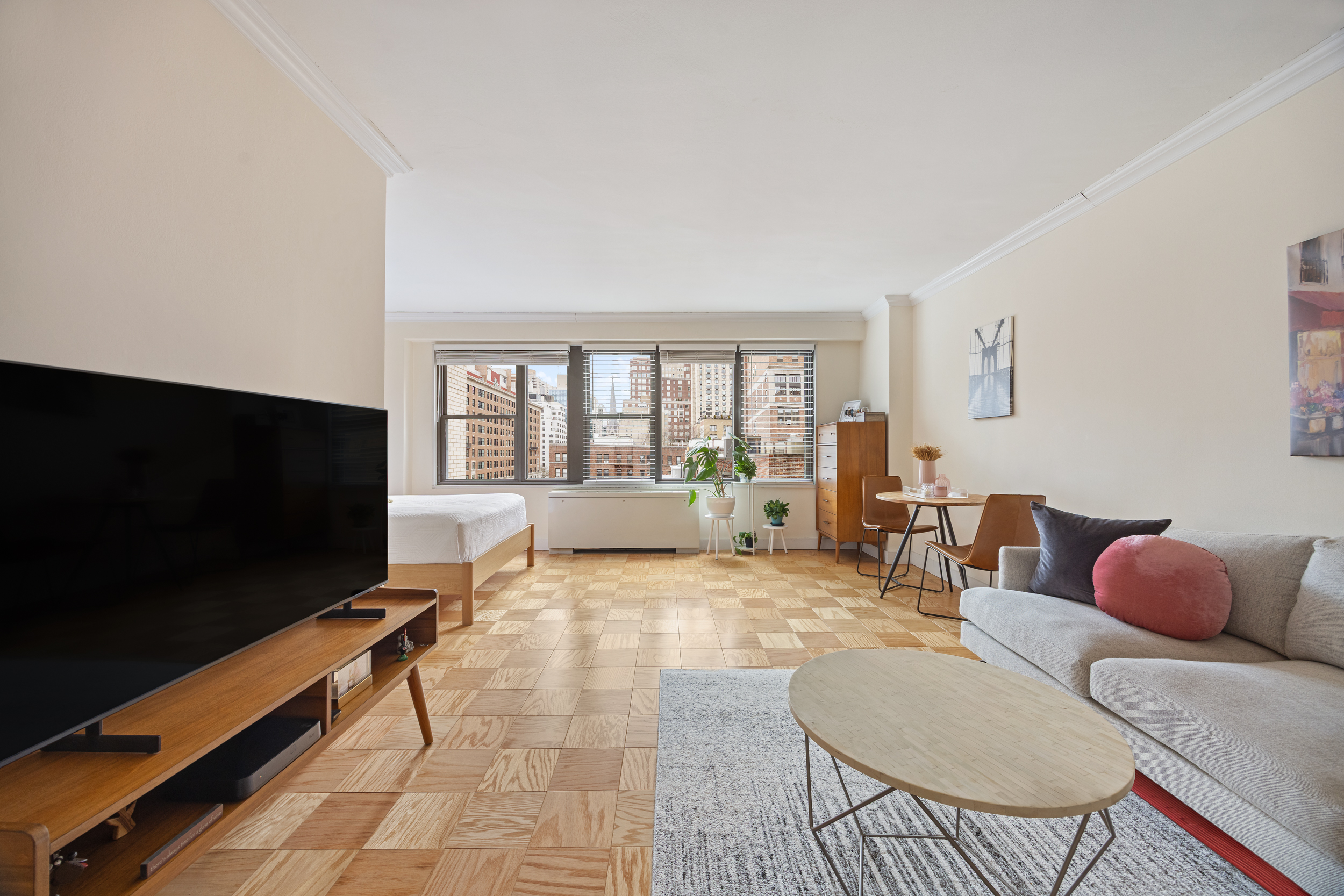 120 East 90th Street, Unit 7A Manhattan, NY 10128 - Photo 2 of 8 a living room with furniture and a flat screen tv